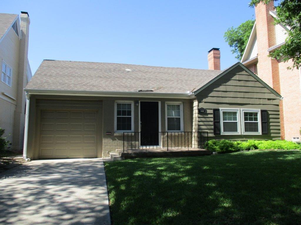 a front view of a house with a garden and yard