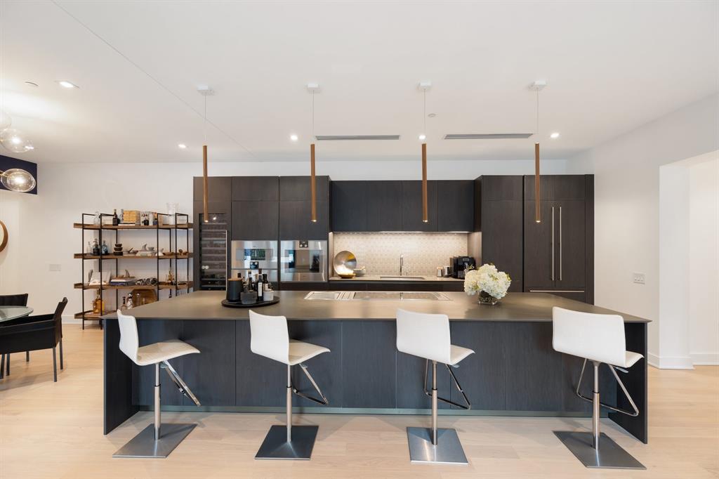 a kitchen with a table chairs stove and cabinets