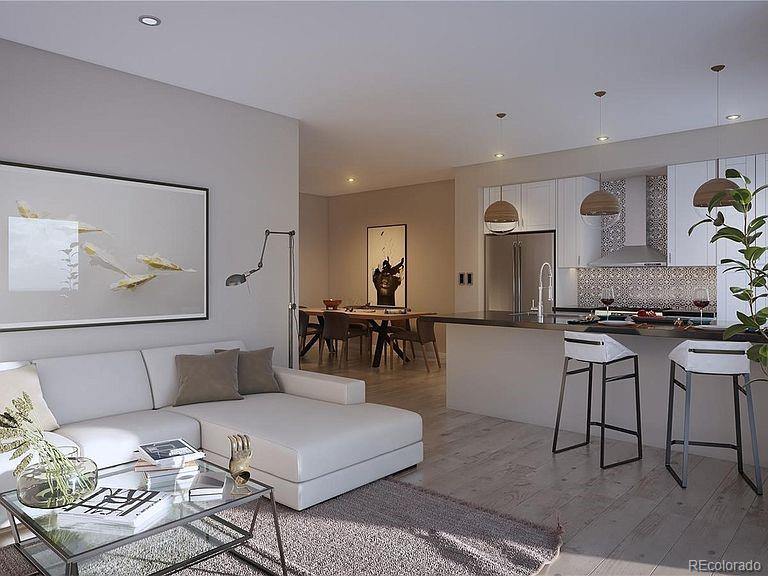 a living room with furniture and kitchen view