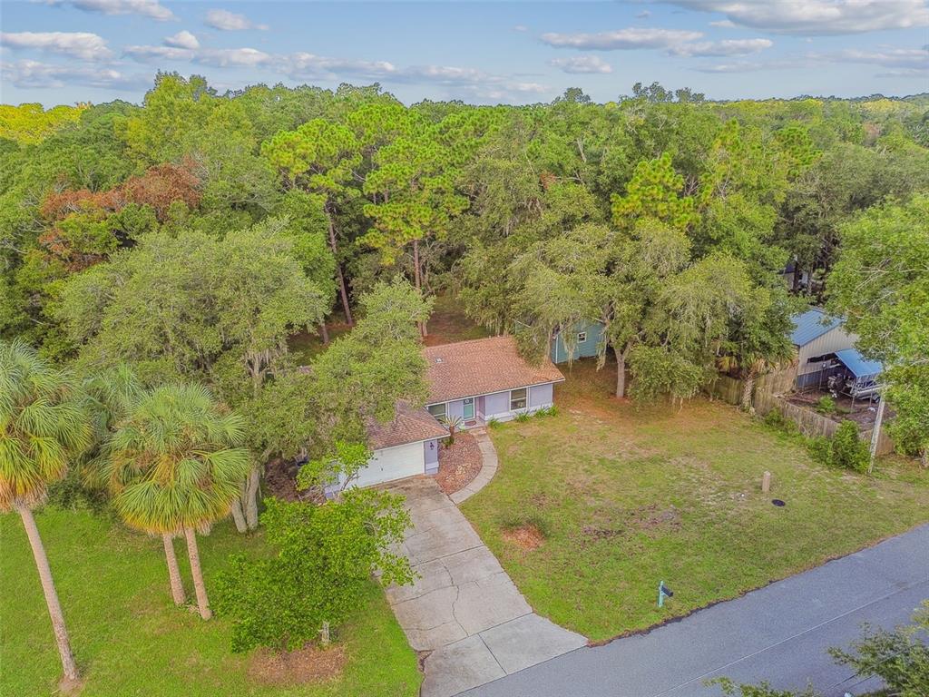 an aerial view of a house with a yard