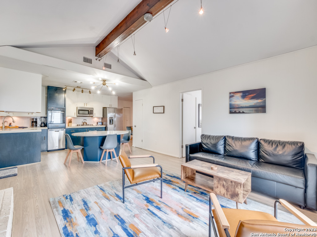 a living room with furniture and a rug