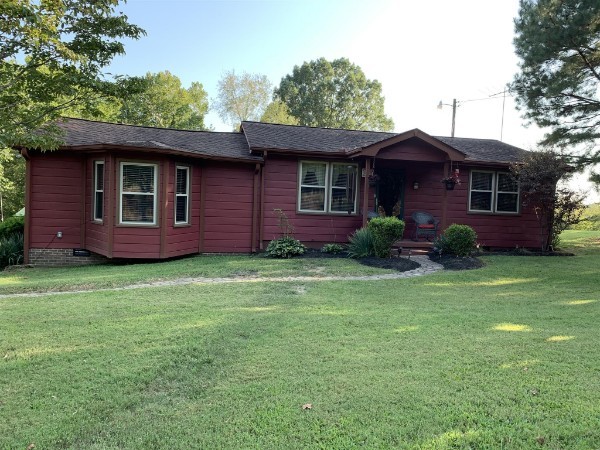 a view of a brick house with a yard