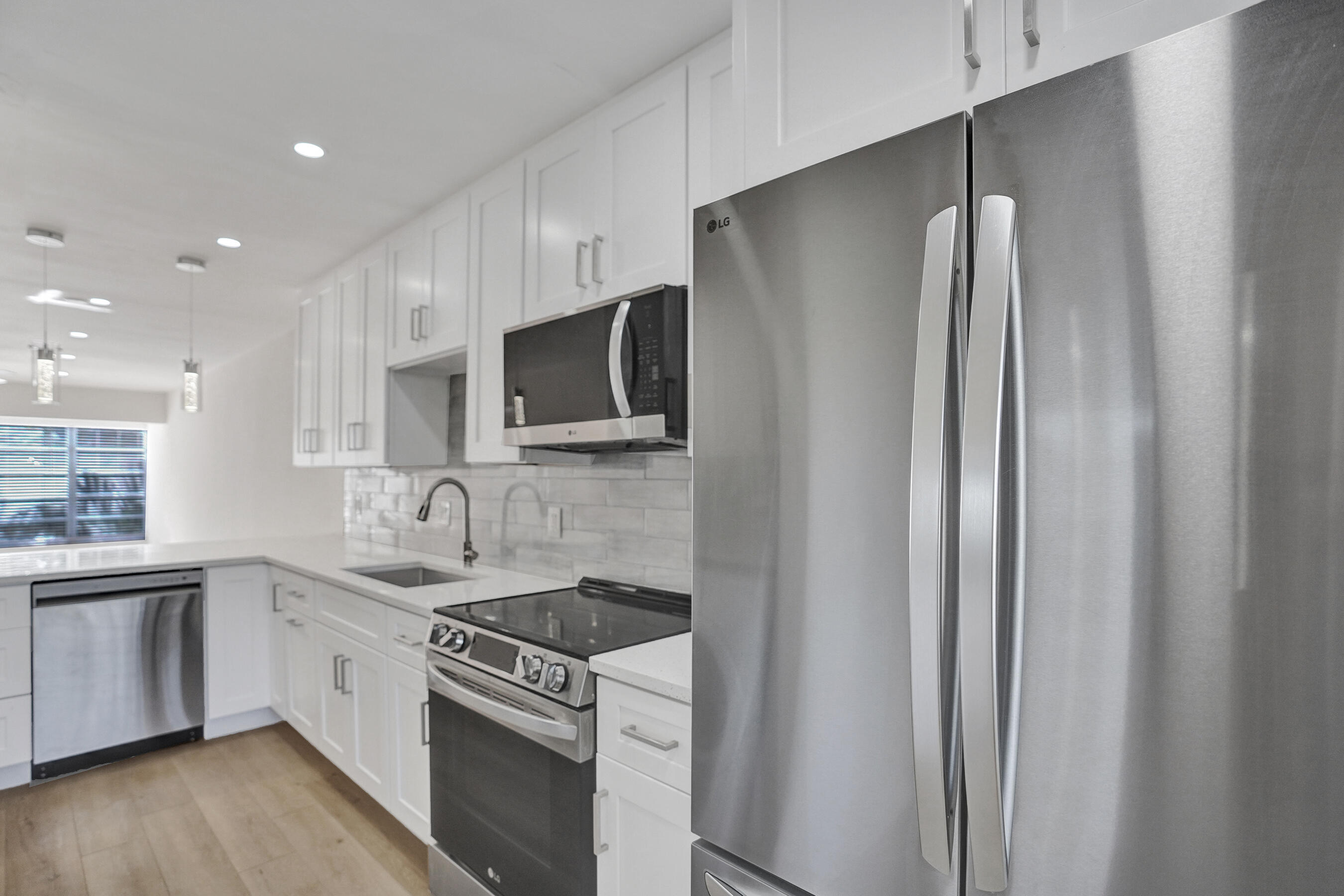 a kitchen with stainless steel appliances a refrigerator stove and sink