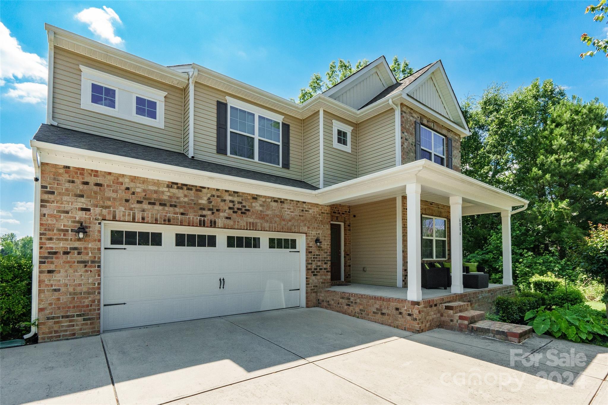 a front view of a house with a garage