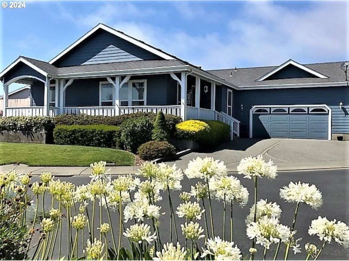 a front view of a house with a yard and outdoor seating