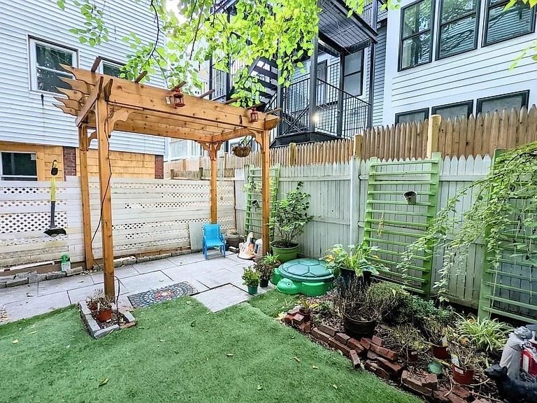 a view of backyard with a garden and plants