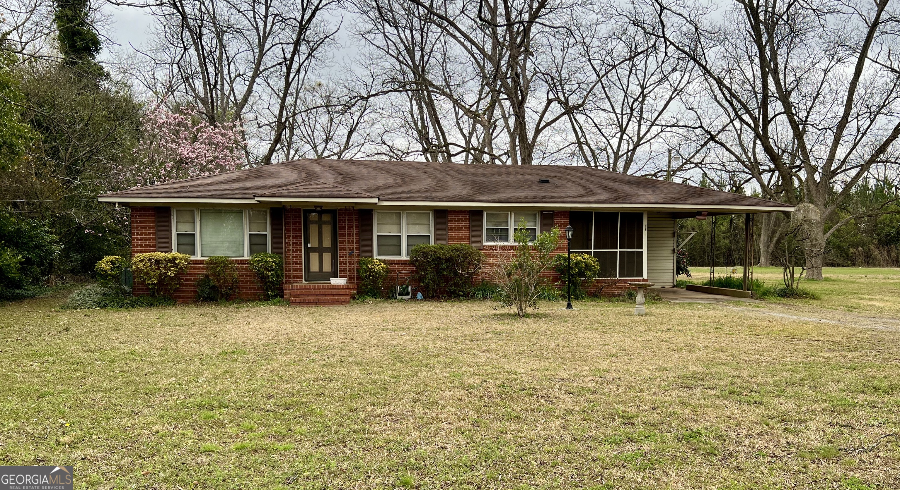 a front view of a house with a garden