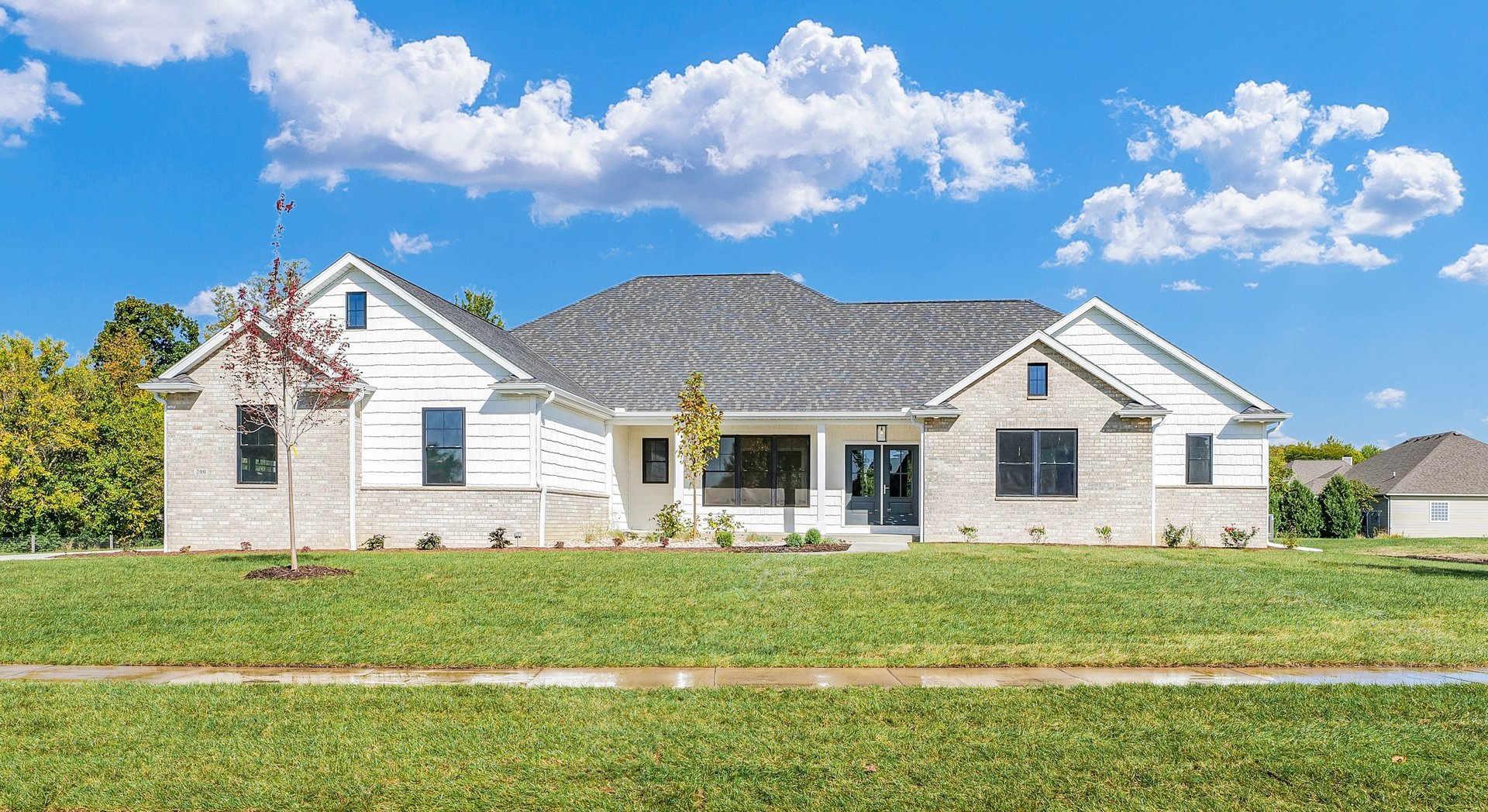 a front view of house with yard and green space