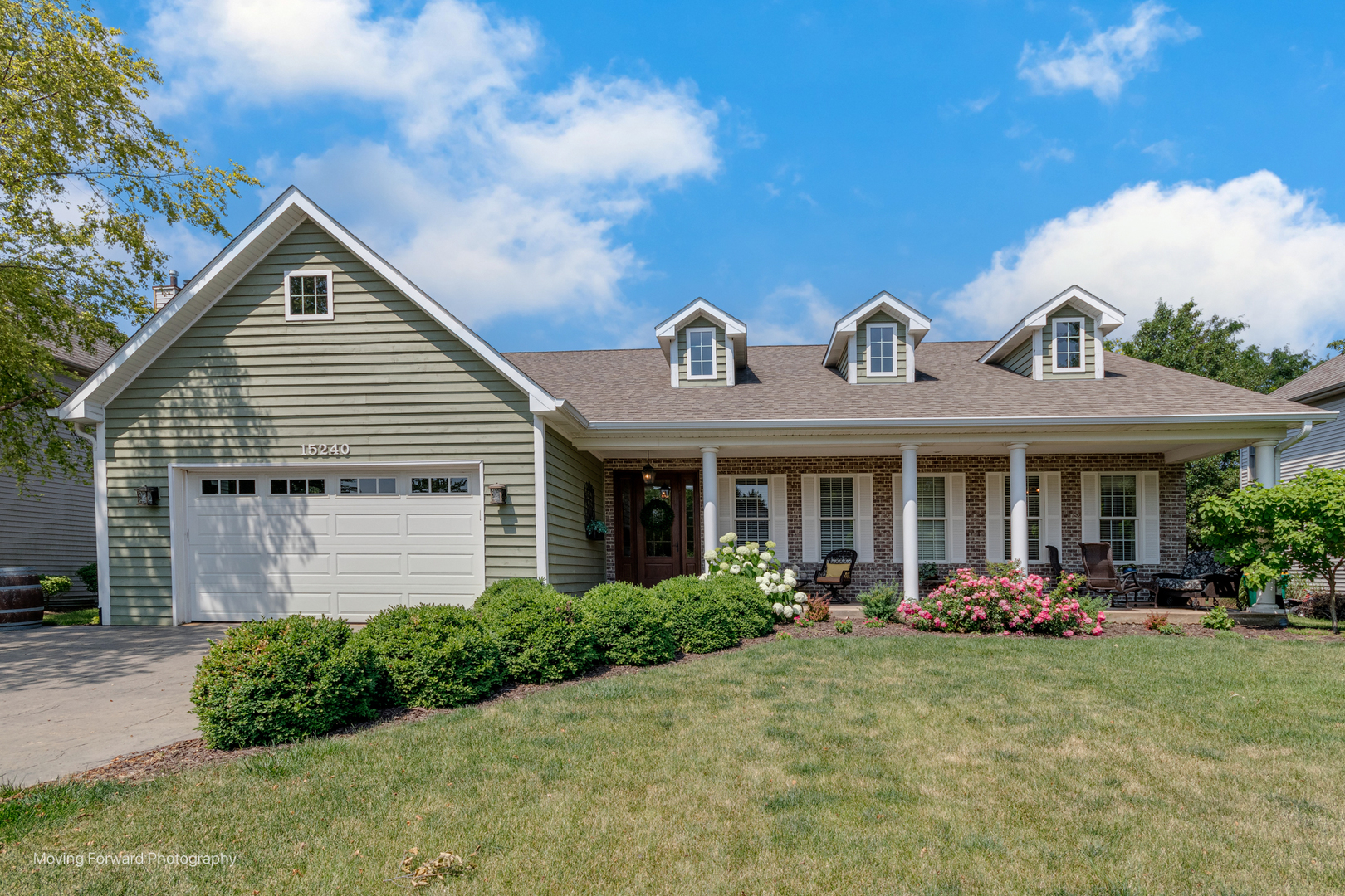 a front view of house with yard and green space