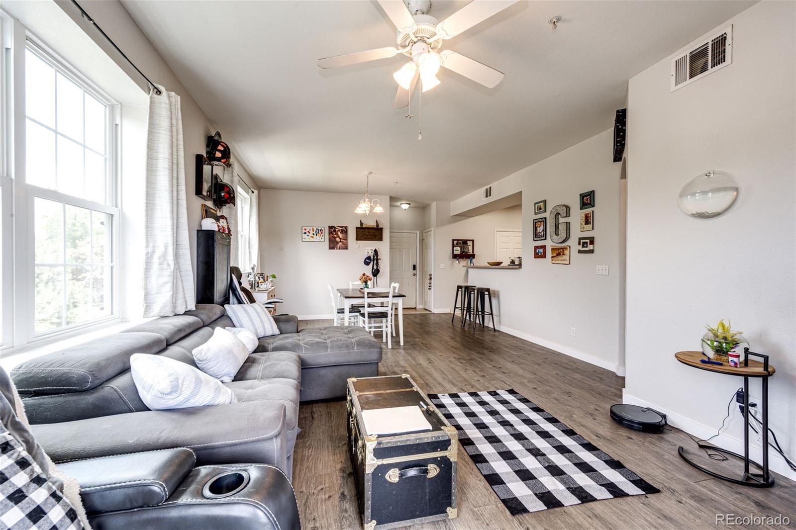 a living room with furniture and wooden floor