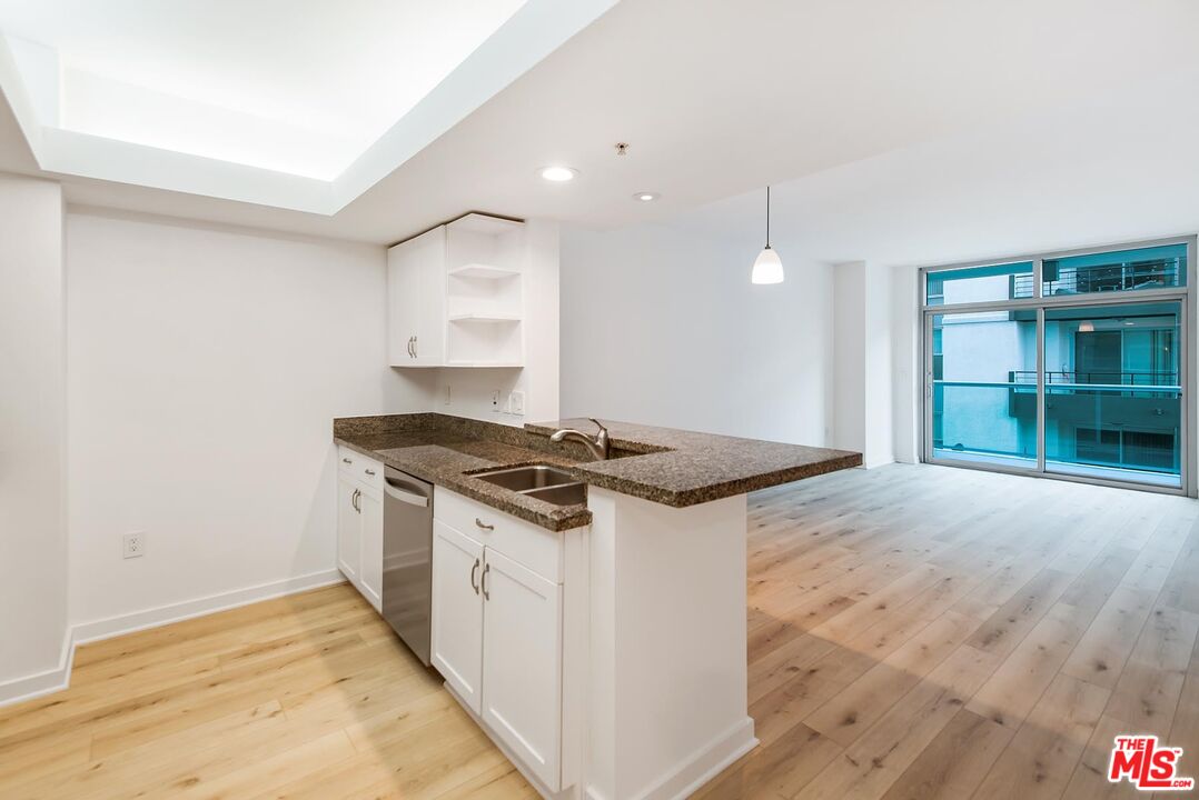 a kitchen that has a sink and a stove