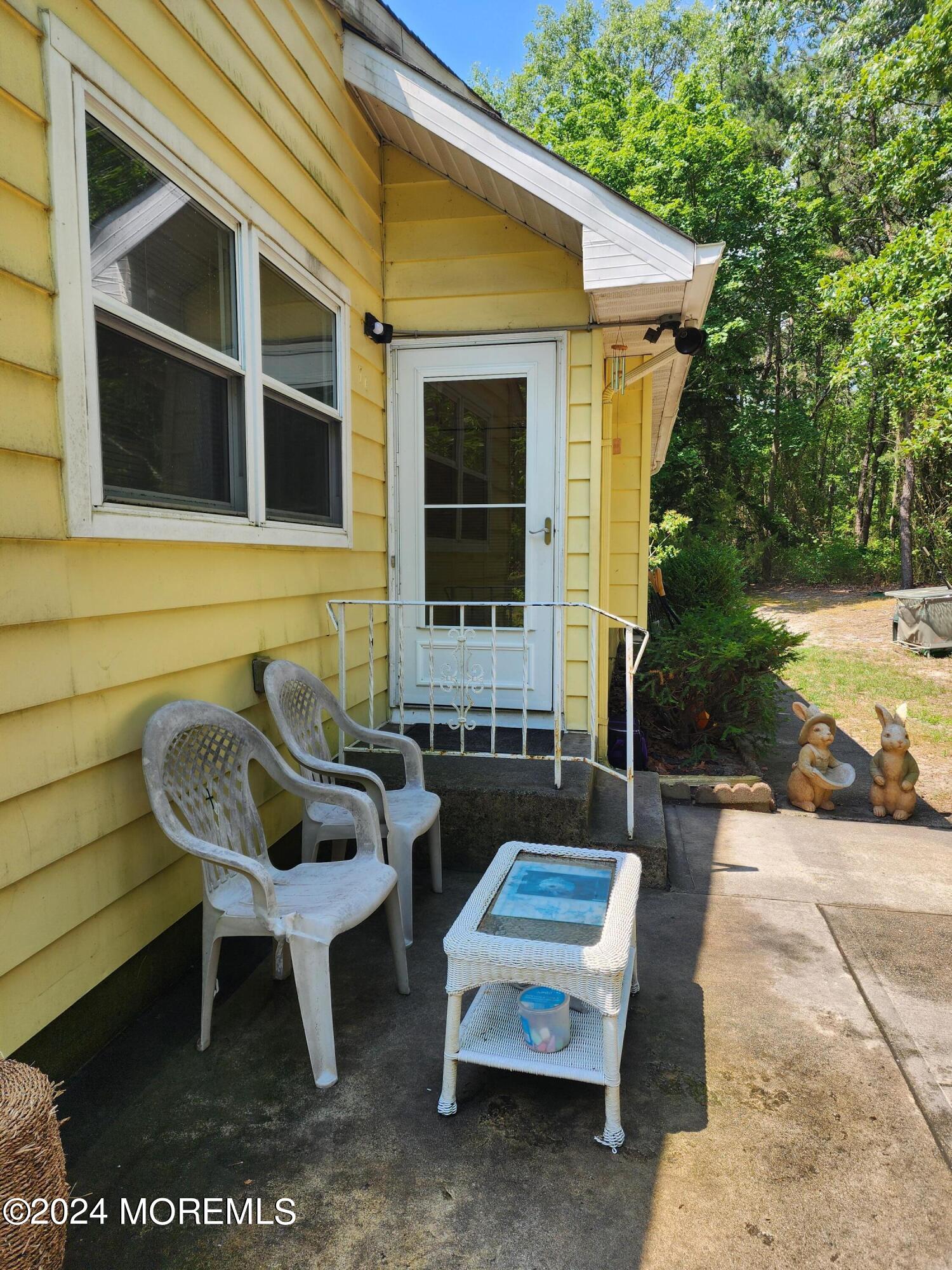 a view of a house with a yard and sitting area