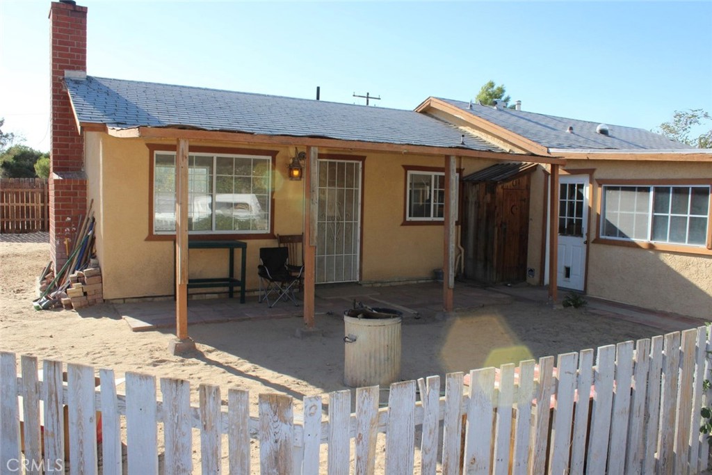 a view of a house with wooden deck and furniture