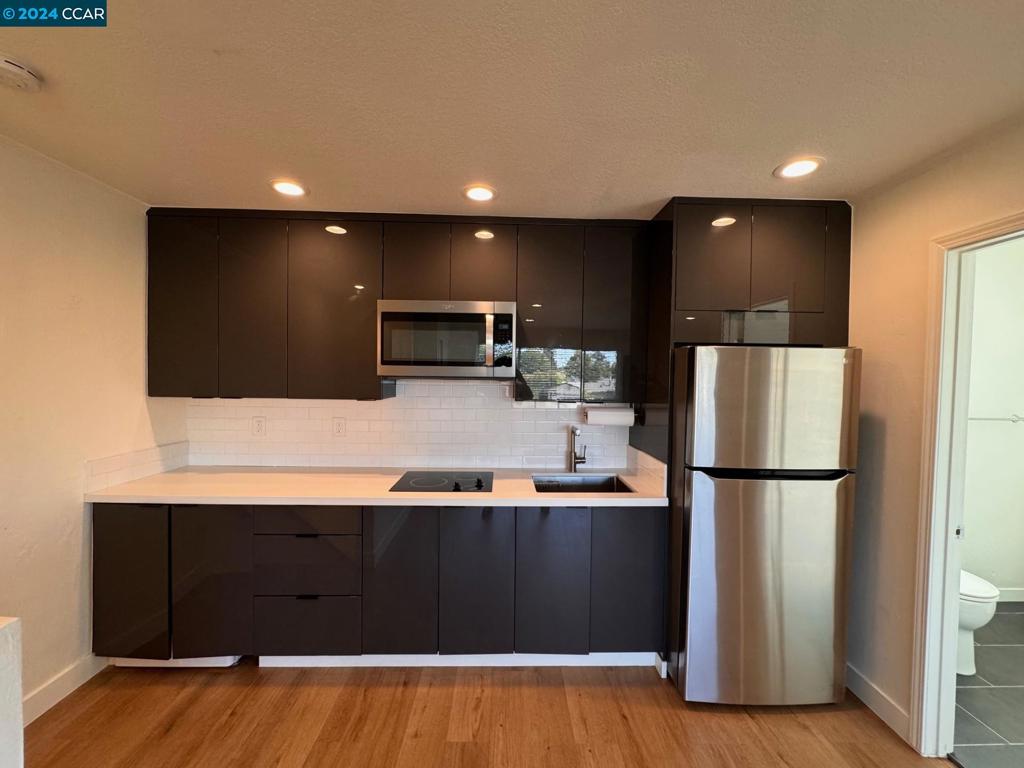 a kitchen with stainless steel appliances a refrigerator and a stove