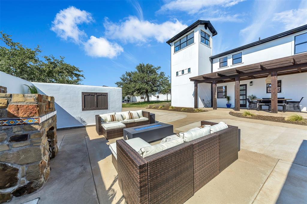 a view of a patio with couches and a fireplace