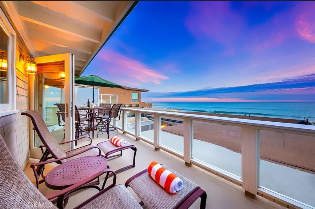 a view of a chairs and table in a balcony