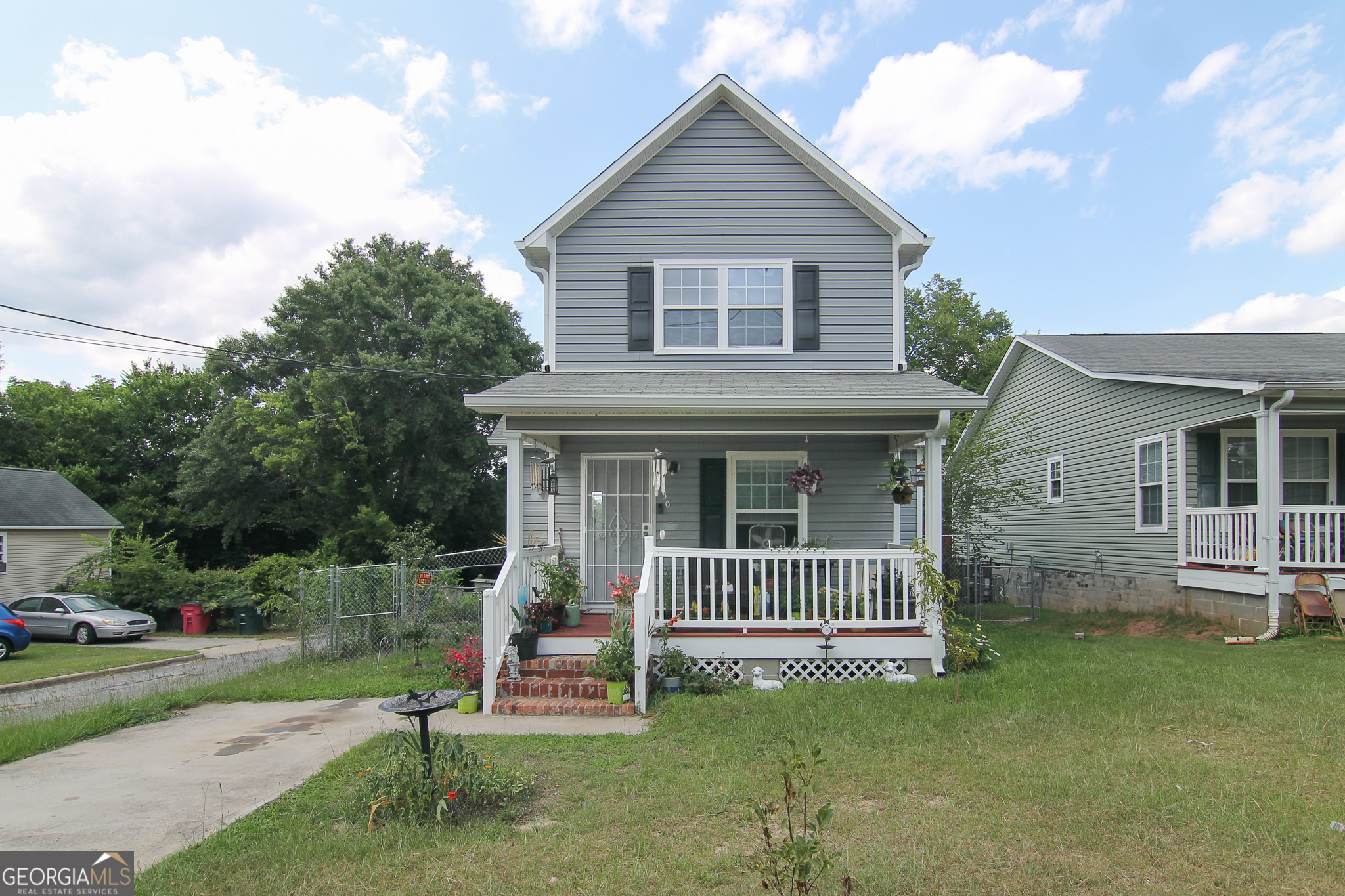 a view of a house with a yard and a fence