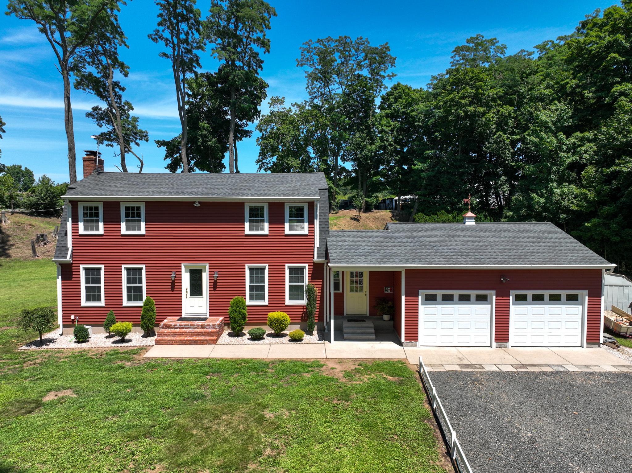 front view of a brick house with a yard