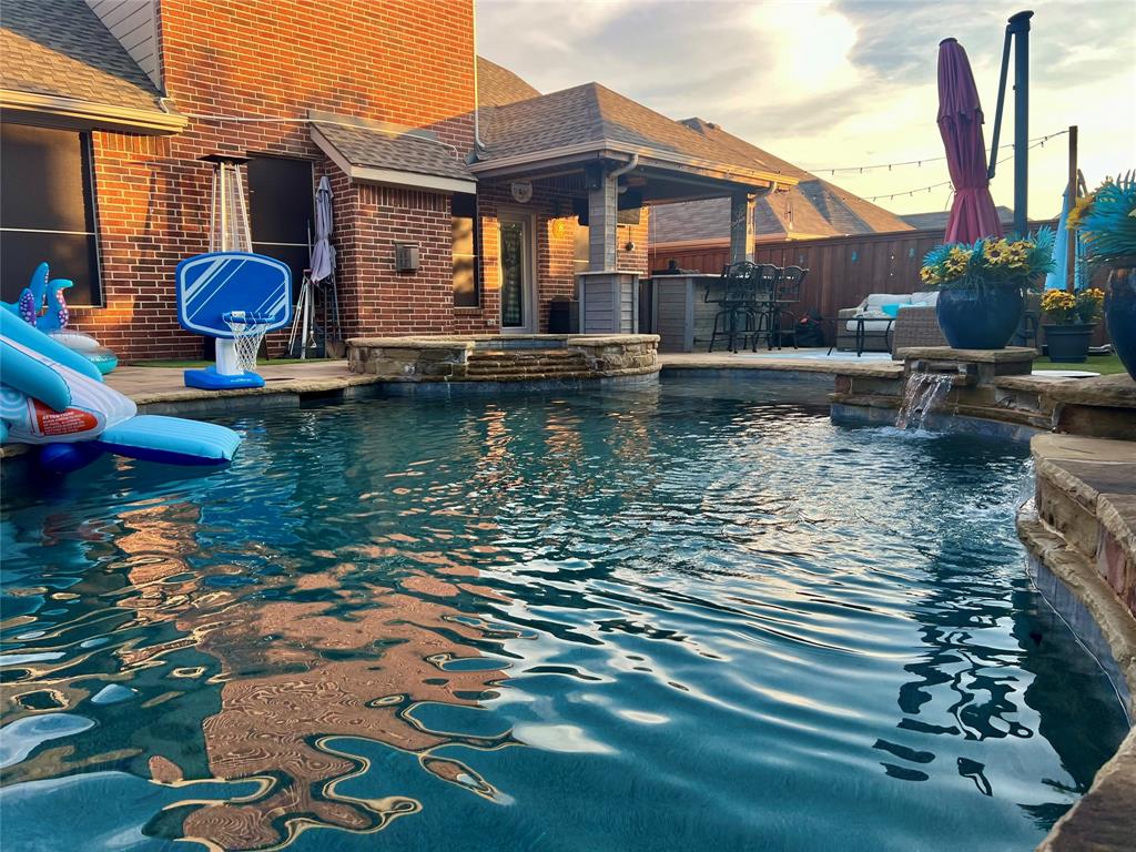 a view of a house with pool and chairs