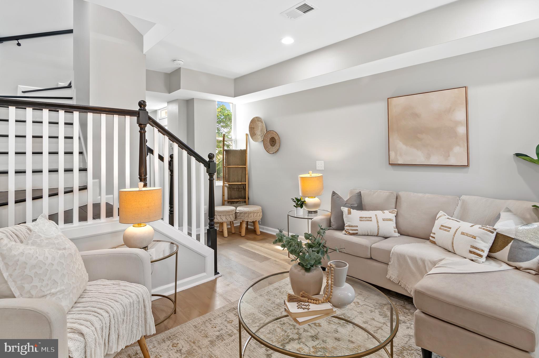 a living room with furniture or couch and a potted plant