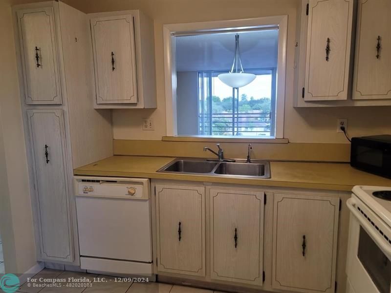 a kitchen with appliances cabinets and a sink