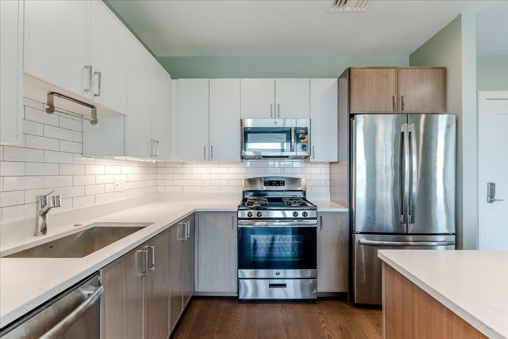 a kitchen with a stove a sink and a refrigerator