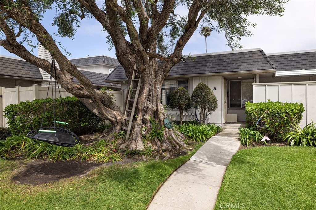 a front view of a house with a yard and potted plants