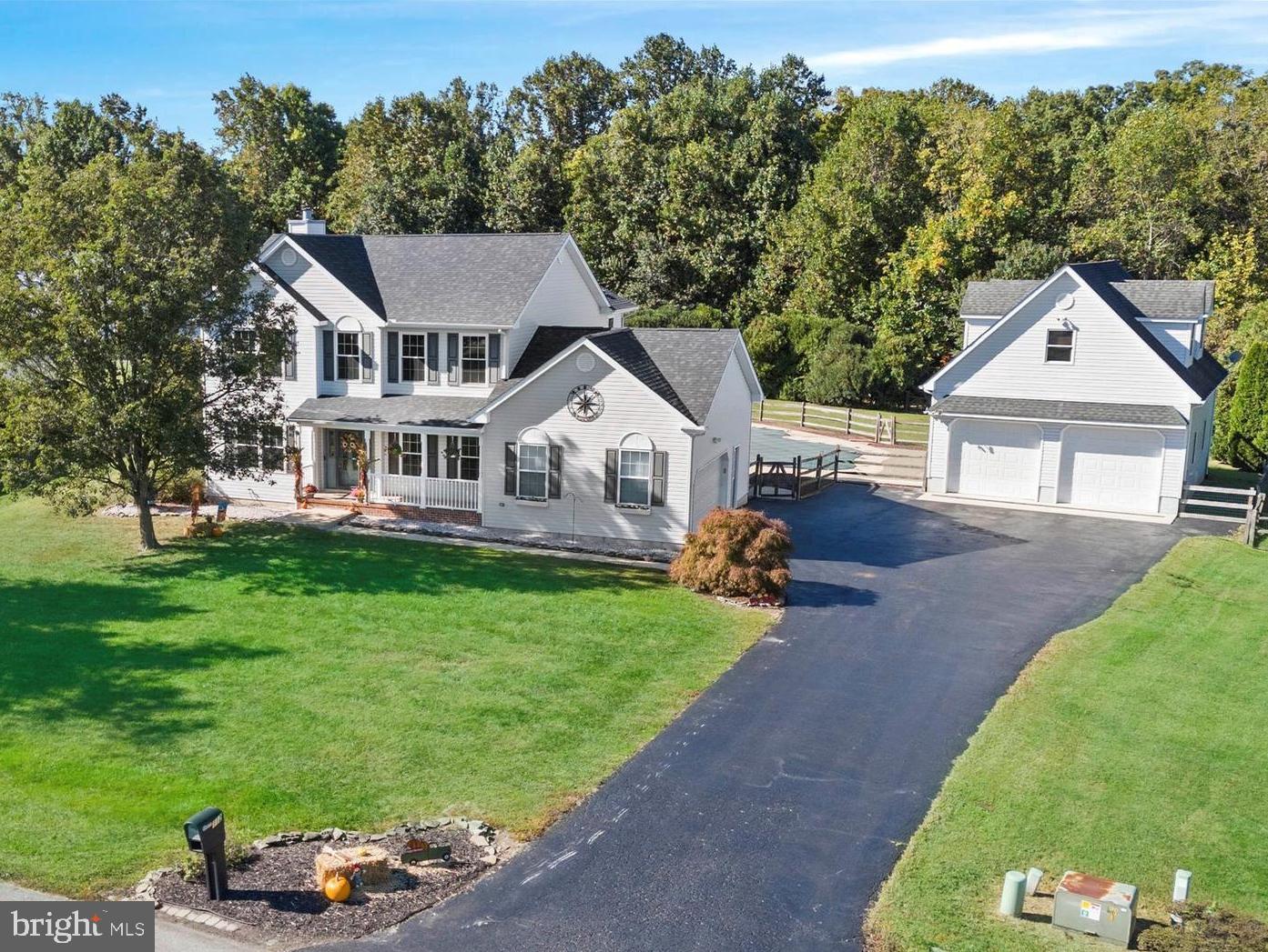 a aerial view of a house with a yard table and chairs