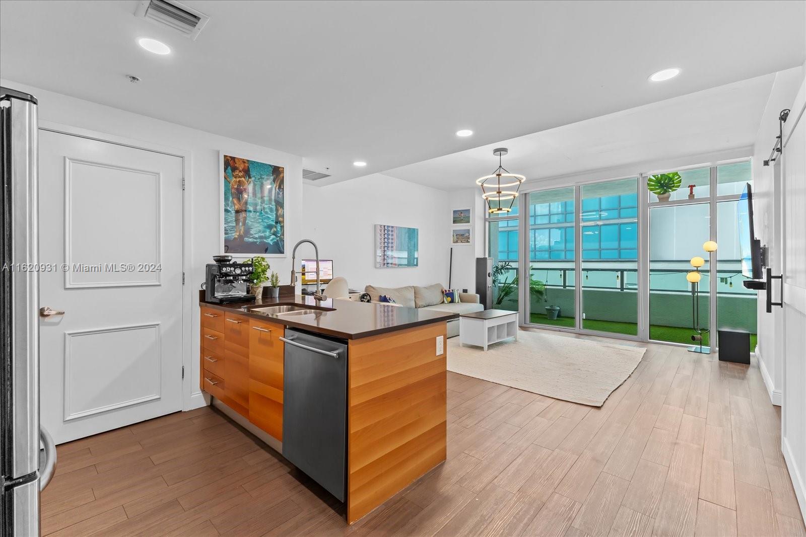 a kitchen with stainless steel appliances granite countertop a stove and a wooden floors