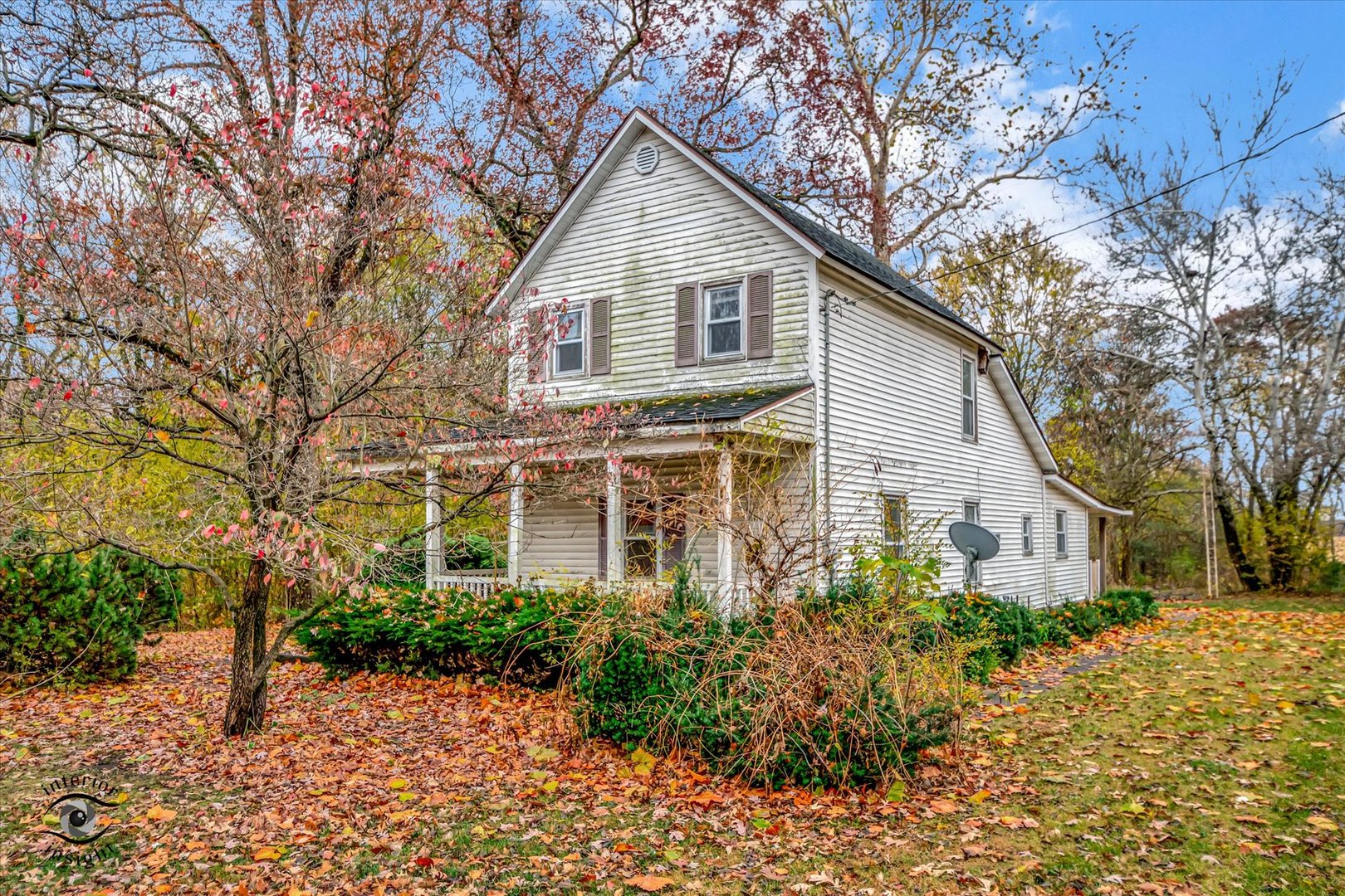 a front view of a house with a yard and potted plants