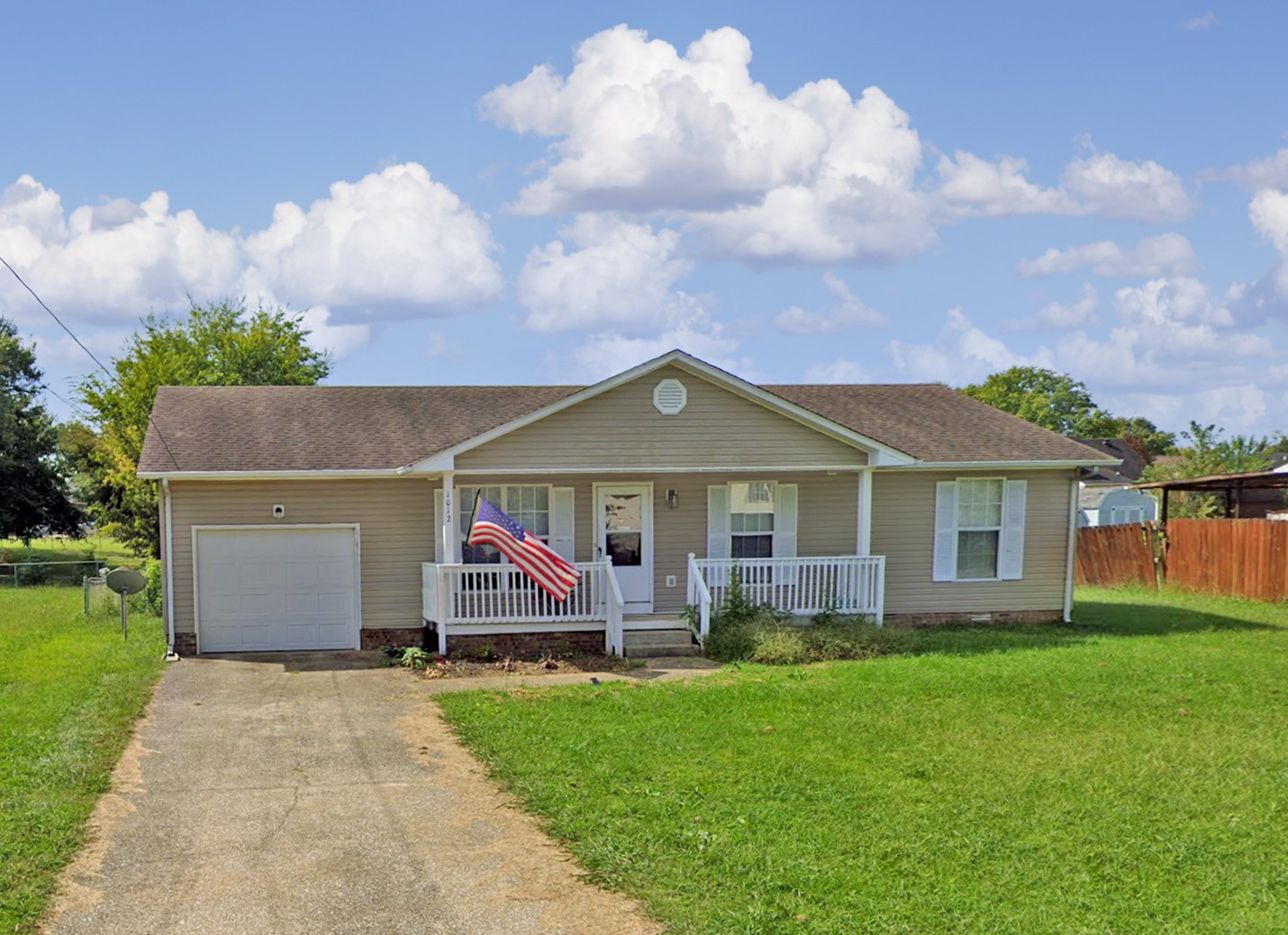 a front view of house with yard and green space