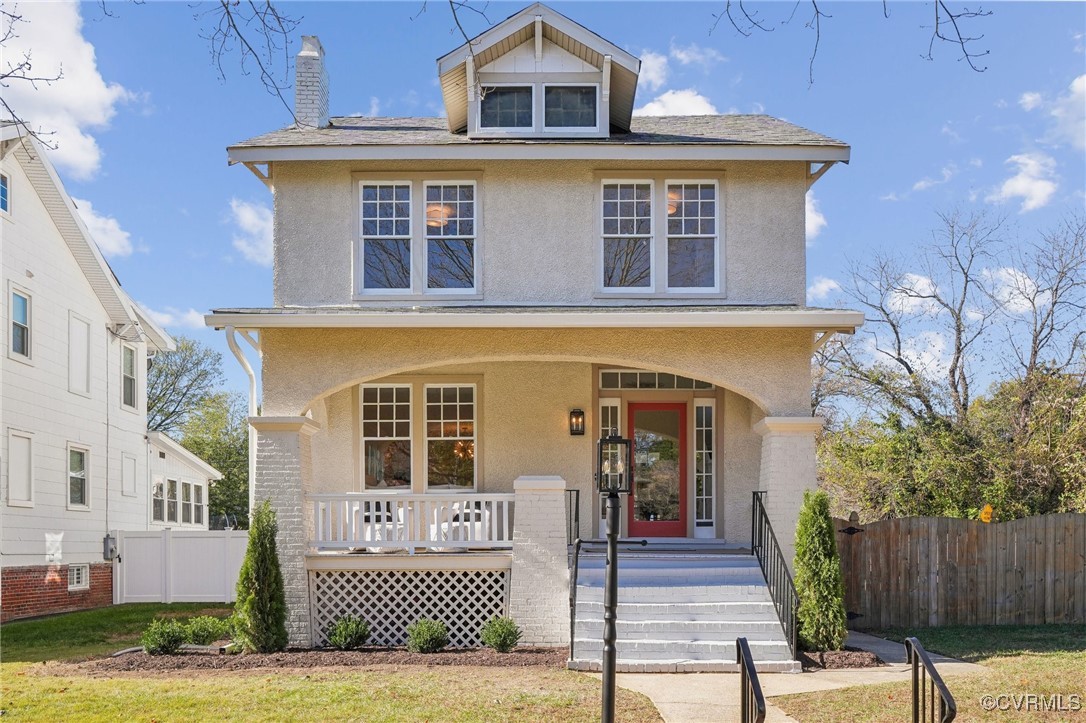 View of front of house with a porch and a front la