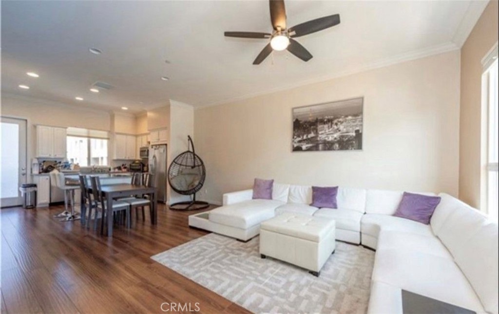 a living room with furniture a rug and a chandelier