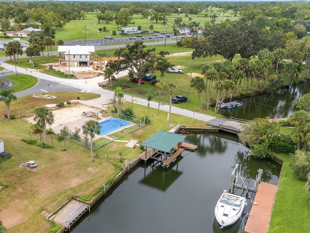 an aerial view of residential houses with outdoor space and lake view