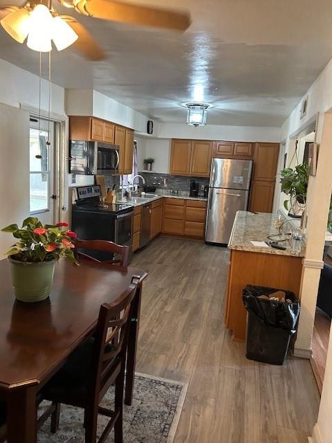 a kitchen with a table chairs stove and wooden floor