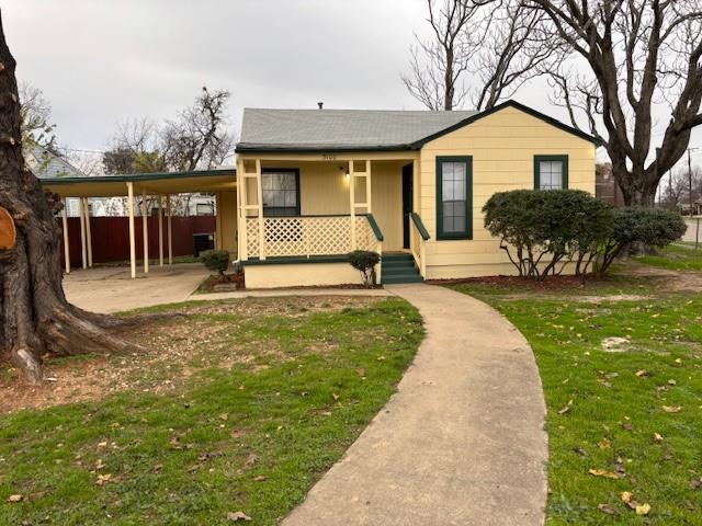 a front view of a house with a yard table and chairs