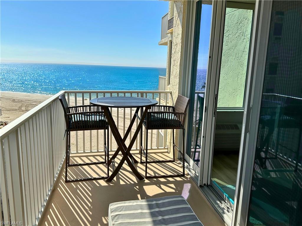 Balcony with a view of the beach and a water view