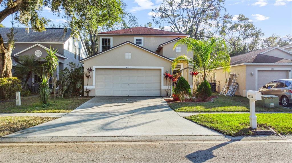 a front view of a house with a yard and garage