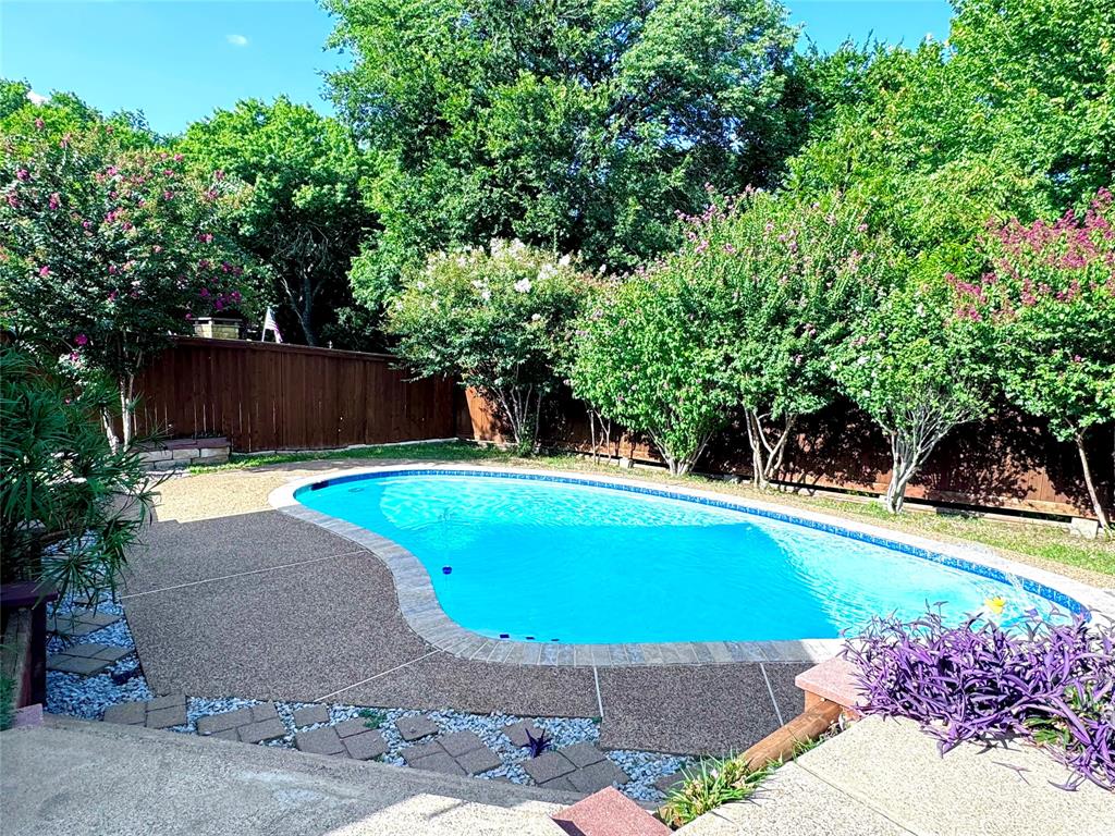 a view of a swimming pool with an outdoor space and seating area