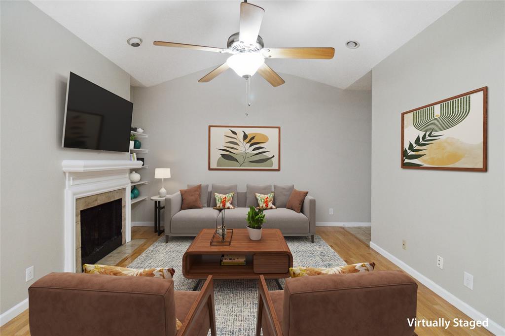 a living room with furniture a flat screen tv and a fireplace