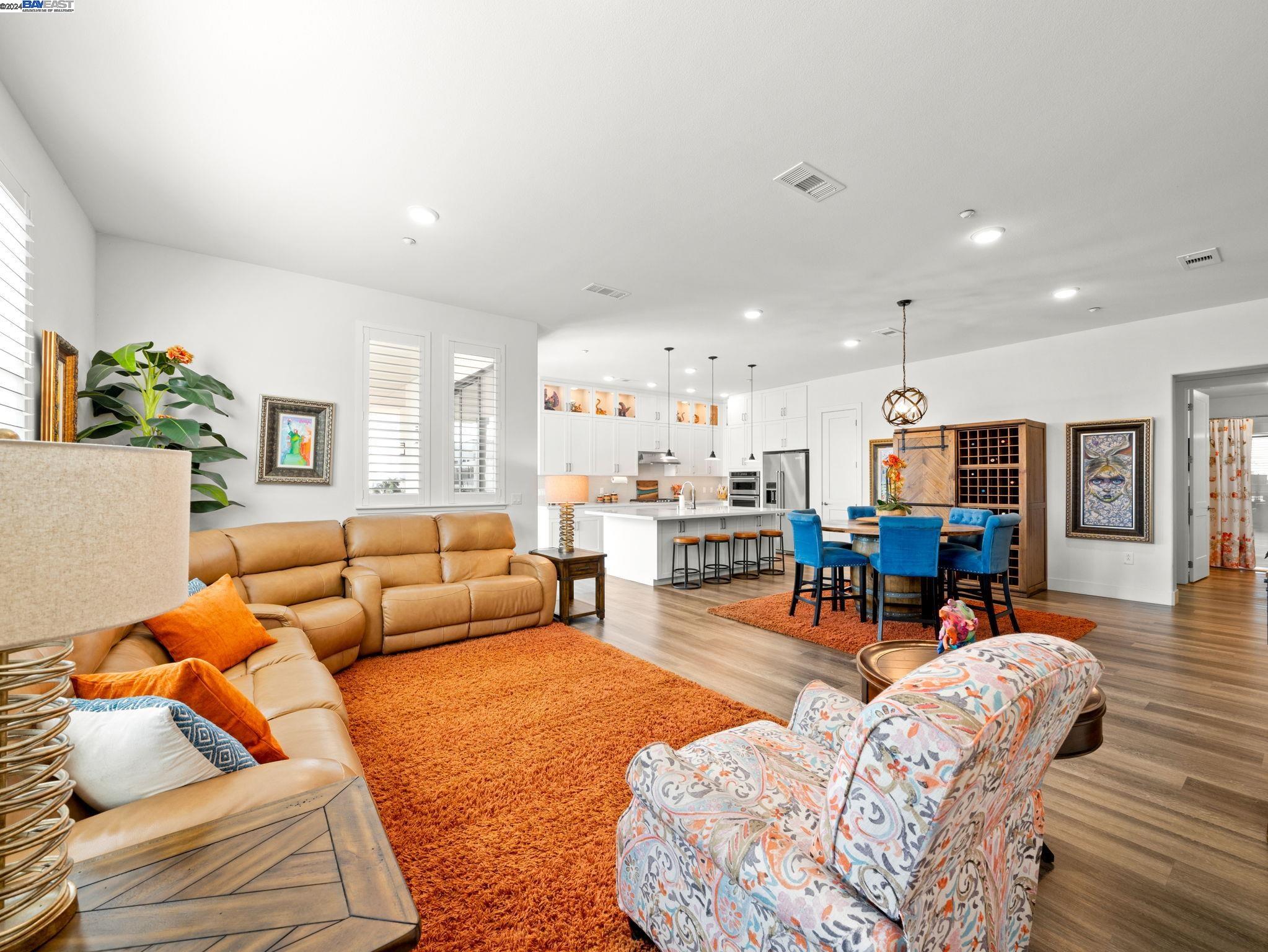 a living room with furniture and view of kitchen