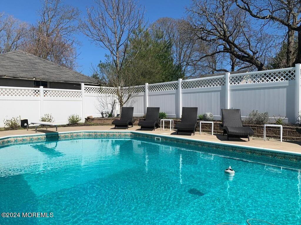 a view of a swimming pool with chairs