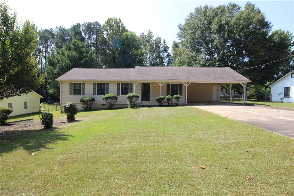 a front view of a house with a yard table and chairs