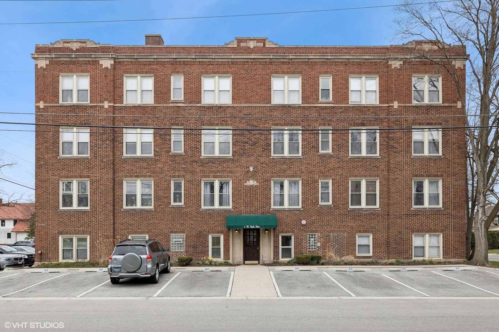 a front view of a building with car parked