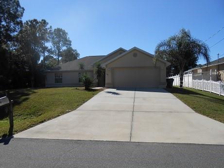 a side view of a house with a yard