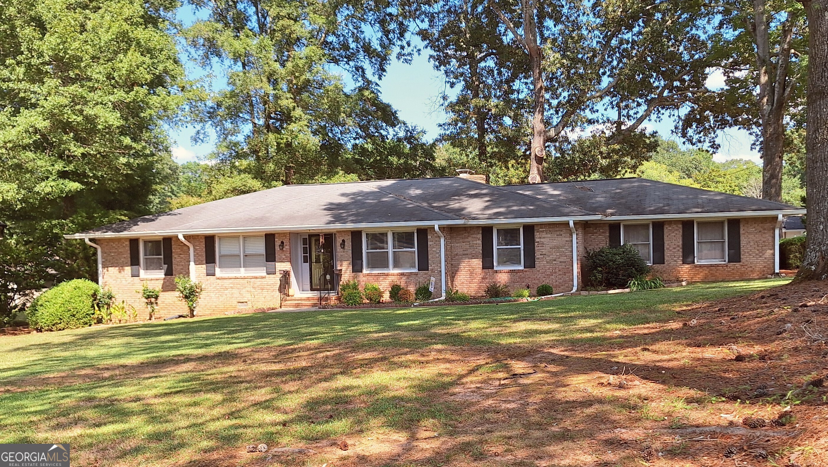 a front view of a house with a garden