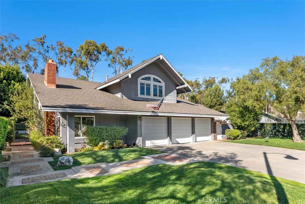 a front view of a house with a garden and yard