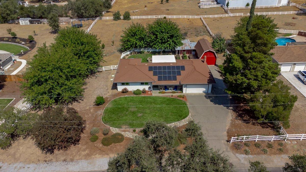 an aerial view of a house with a yard and lake view