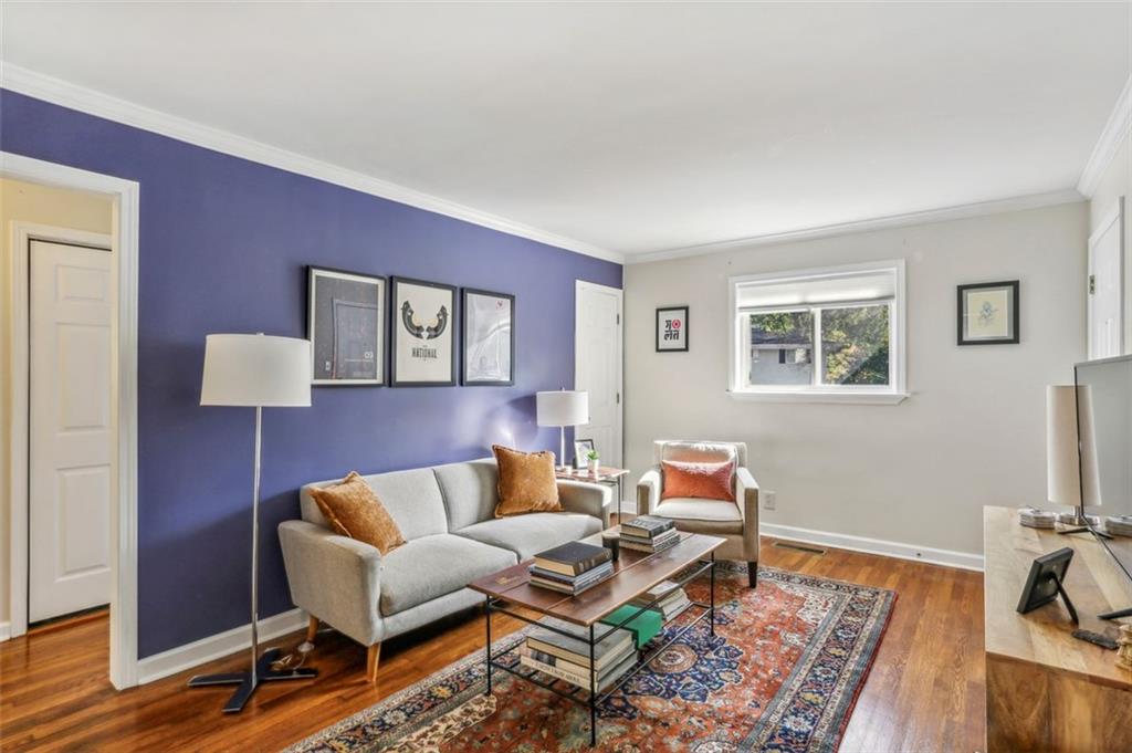 a living room with furniture and wooden floor