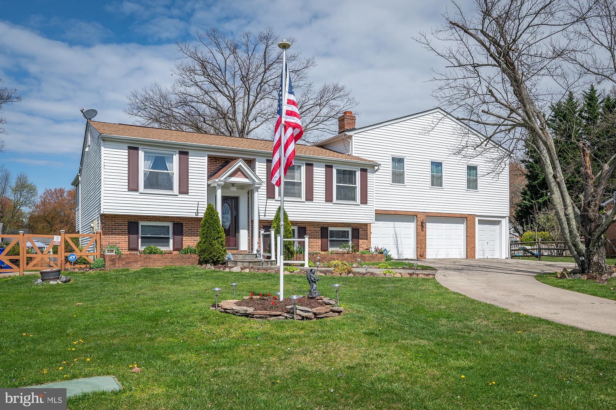 a front view of a house with a yard and trees